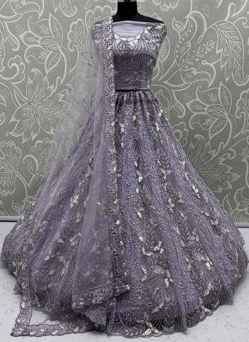 For A Fancy Designer Look,Grab These Lehenga Choli With Dupatta in Fine Colored.These Lehenga And Choli Are Net And Dupatta Are Fabricated On Net Pair.Its Beautified With Fancy Designer Dori,Rainbow Sequance Embroidery With Zarkan Work. 