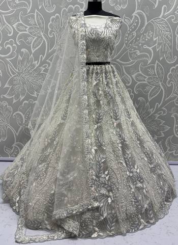 For A Fancy Designer Look,Grab These Lehenga Choli With Dupatta in Fine Colored.These Lehenga And Choli Are Net And Dupatta Are Fabricated On Net Pair.Its Beautified With Fancy Designer Dori,Rainbow Sequance Embroidery With Zarkan Work. 