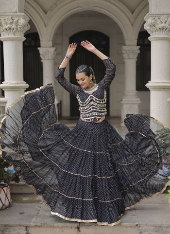 Attractive These Navratri Special Lehenga Choli in Fine Colored. These Lehenga Are Faux Georgette And Blouse Are Fabricated On Faux Georgette Fabriced. It is Beautified With Lahariya Printed Designer With Mirror Lace Work.