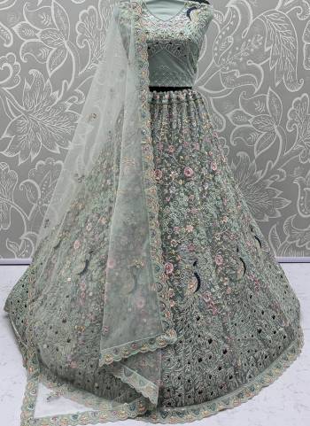 For A Fancy Designer Look,Grab These Lehenga Choli With Dupatta in Fine Colored.These Lehenga And Choli Are Net And Dupatta Are Fabricated On Net Pair.Its Beautified With  Peacock Pattern Crafted In Dori,Thread Embroidery With Zircon Diamond Work. 