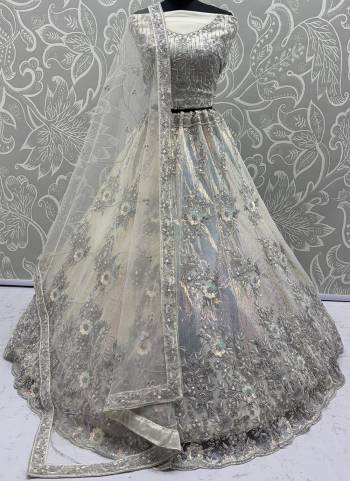 For A Fancy Designer Look,Grab These Lehenga Choli With Dupatta in Fine Colored.These Lehenga And Choli Are Net And Dupatta Are Fabricated On Net Pair.Its Beautified With Multy Thread, Rainbow Sequance Embroidery,Zarcon Diamond Work. 