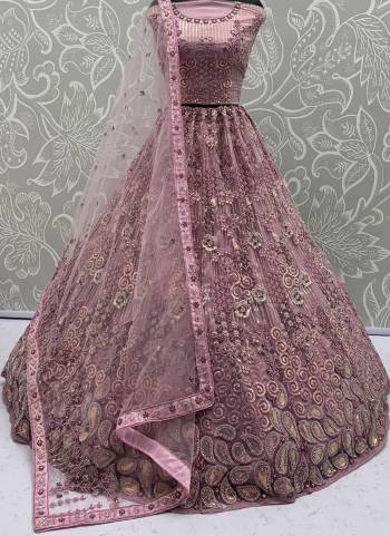 For A Fancy Designer Look,Grab These Lehenga Choli With Dupatta in Fine Colored.These Lehenga And Choli Are Net And Dupatta Are Fabricated On Net Pair.Its Beautified With Multy Thread,Sequance Embroidery,Zarcon Diamond Work. 