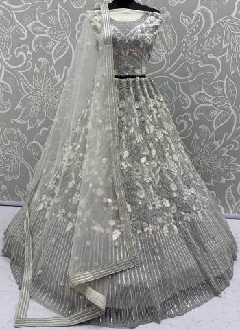 For A Fancy Designer Look,Grab These Lehenga Choli With Dupatta in Fine Colored.These Lehenga And Choli Are Net And Dupatta Are Fabricated On Soft Net Pair.Its Beautified With Dori, Sequance,Thread Embroidery,Zarkon Diamond Work. 