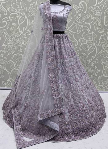 For A Fancy Designer Look,Grab These Lehenga Choli With Dupatta in Fine Colored.These Lehenga And Choli Are Net And Dupatta Are Fabricated On Soft Net Pair.Its Beautified With Heavy Dori, Sequance,Jari Embroidery,Zarkon Diamond Work. 