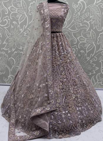 For A Fancy Designer Look,Grab These Lehenga Choli With Dupatta in Fine Colored.These Lehenga And Choli Are Net And Dupatta Are Fabricated On Soft Net Pair.Its Beautified With Heavy Multy Thread,Dori,Sequance Embroidery,Zarkon Diamond Work. 