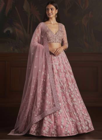 For A Fancy Designer Look,Grab These Lehenga Choli With Dupatta in Fine Colored.These Lehenga And Choli Are Net And Dupatta Are Fabricated On Soft Net Pair.Its Beautified With Fancy Dori, Sequance Embroidery,Zarcon Diamond Work. 