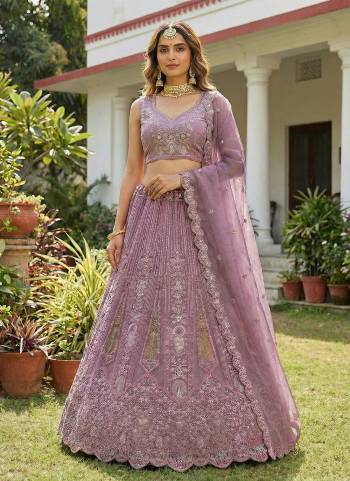 For A Fancy Designer Look,Grab These Lehenga Choli With Dupatta in Fine Colored.These Lehenga And Choli Are Bridal Net And Dupatta Are Fabricated On Soft Net Pair.Its Beautified With Fancy Dori, Sequance,Multy Thread,Jari Embroidery,Zarcon Diamond Work. 
