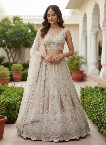 For A Fancy Designer Look,Grab These Lehenga Choli With Dupatta in Fine Colored.These Lehenga And Choli Are Bridal Net And Dupatta Are Fabricated On Soft Net Pair.Its Beautified With Fancy Dori, Sequance,Multy Thread,Jari Embroidery,Zarcon Diamond Work. 