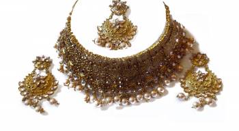 Give An Enhanced Look To Your Personality By Pairing Up This Beautiful Necklace Set With Your Ethnic Attire. This Pretty Set Is In Golden Color Beautified With Stone Work. Buy Now.