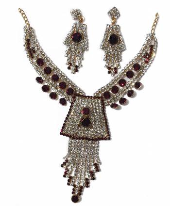 Give An Enhanced Look To Your Personality By Pairing Up This Beautiful Necklace Set With Your Ethnic Attire. This Pretty Set Is In Golden Color Beautified With Stone Work. Buy Now.