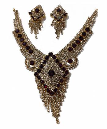 Give An Enhanced Look To Your Personality By Pairing Up This Beautiful Necklace Set With Your Ethnic Attire. This Pretty Set Is In Golden Color Beautified With Stone Work. Buy Now.