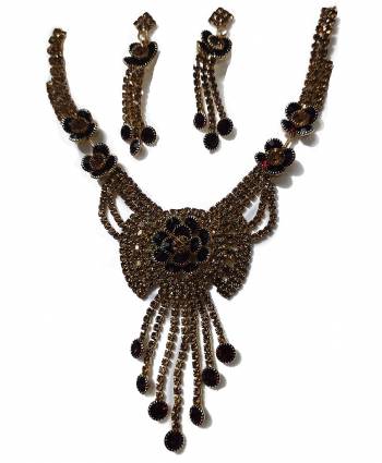 Give An Enhanced Look To Your Personality By Pairing Up This Beautiful Necklace Set With Your Ethnic Attire. This Pretty Set Is In Golden Color Beautified With Stone Work. Buy Now.