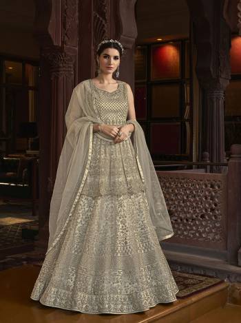 Grab This Pretty Designer Suit In Light Base Color For The Upcoming Festive And Wedding Season. Its Top Is Butterfly Nett Based Paired With Are Silk Bottom And Butterfly Nett Fabricated Dupatta. It Is Beautified With Designer Heavy Embroidery And Stone Work. Buy Now. 

