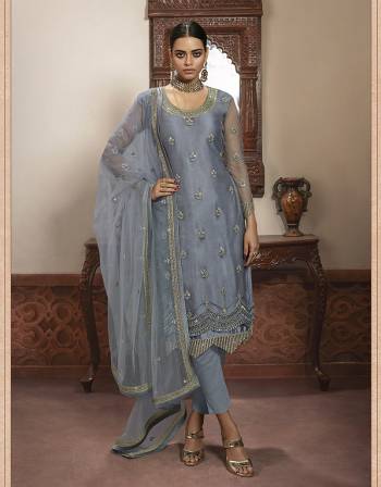 Beautiful looks in this Grey COLOR fabric super net with inner  and GHARARA semi stiched type and bottom chudidar style suit with embroidered floral patterns on the yoke and sleeves. Comes with matching net dupatta