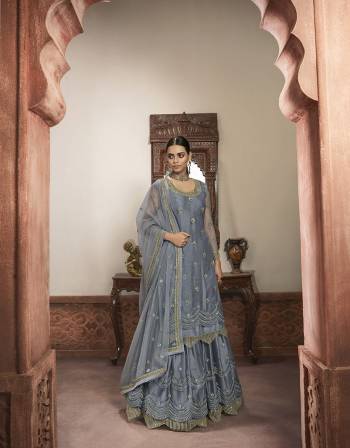 Beautiful looks in this Grey COLOR fabric super net with inner  and GHARARA semi stiched type and bottom chudidar style suit with embroidered floral patterns on the yoke and sleeves. Comes with matching net dupatta