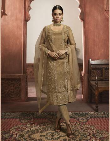 Beautiful looks in this Beige COLOR fabric Super net with inner  and GHARARA semi stiched type and bottom chudidar style suit with embroidered floral patterns on the yoke and sleeves. Comes with matching net dupatta