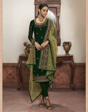 Beautiful looks in this Green COLOR fabric faux georgette with inner  and GHARARA semi stiched type and bottom chudidar style suit with embroidered floral patterns on the yoke and sleeves. Comes with matching net dupatta