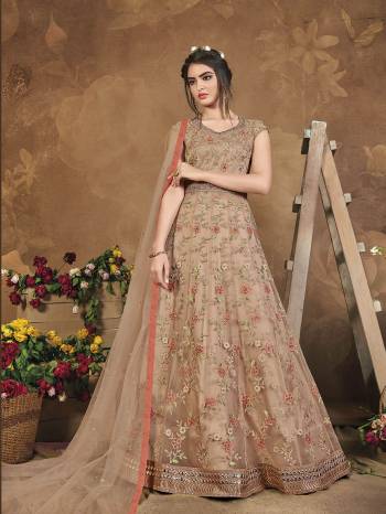 Flaunt Your Rich And Elegant Taste Wearing This Heavy Designer Floor Length Suit In Fine Color. Its Floor Length Top Is Butterfly Net Based Beautified With Attractive Contrasting Embroidery Paired With Silk Base Bottom And Butterfly Net Fabricated Dupatta. Buy Now.

