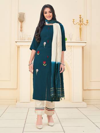 Here Is A Pretty Dress Material In Dark Color With Attractive Hand Embroidery Work, Get This Stitched As Per Your Desired Fit And Comfort. Its Top Is Fabricated On Rayon Paired With Cotton Khadi Pant With Lace Work And Chanderi Wevon Jari Dupatta. 

