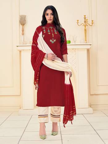 Here Is A Pretty Dress Material In Dark Color With Attractive Hand Embroidery Work, Get This Stitched As Per Your Desired Fit And Comfort. Its Top Is Fabricated On Rayon Paired With Cotton Khadi Pant With Lace Work And Chanderi Wevon Jari Dupatta. 

