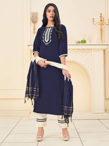 Here Is A Pretty Dress Material In Dark Color With Attractive Hand Embroidery Work, Get This Stitched As Per Your Desired Fit And Comfort. Its Top Is Fabricated On Rayon Paired With Cotton Khadi Pant With Lace Work And Chanderi Wevon Jari Dupatta. 


