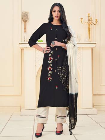 Here Is A Pretty Dress Material In Dark Color With Attractive Hand Embroidery Work, Get This Stitched As Per Your Desired Fit And Comfort. Its Top Is Fabricated On Rayon Paired With Cotton Khadi Pant With Lace Work And Chanderi Wevon Jari Dupatta. 

