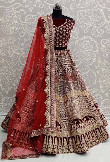 Heavy Designer Lehenga Choli In Maroon Color Fabricated On Velvet Beautified With Heavy Attractive Embroidery And Dupatta Are Soft Net In Maroon Color. 