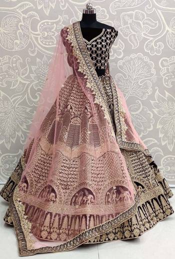 Heavy Designer Lehenga Choli In Black Color Fabricated On Velvet Beautified With Heavy Attractive Embroidery And Dupatta Are Soft Net In Pink Color. 