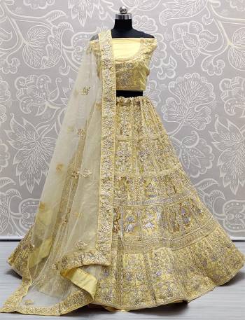 Heavy Designer Lehenga Choli In Yellow Color Fabricated On Net Beautified With Heavy Attractive Embroidery And Dupatta Are Soft Net In Yellow Color. 