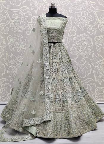 Heavy Designer Lehenga Choli In Grey Color Fabricated On Net Beautified With Heavy Attractive Embroidery And Dupatta Are Soft Net In Grey Color. 