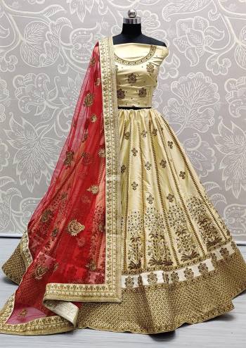 Heavy Designer Lehenga Choli In Beige Color Fabricated On Silk Beautified With Heavy Attractive Embroidery And Dupatta Are Soft Net In Red Color. 