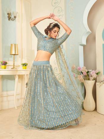 Heavy Designer Lehenga Choli And Dupatta In Light Color Fabricated On Soft Net Beautified With Heavy Attractive Sequance Thread Dori Embroidery. 