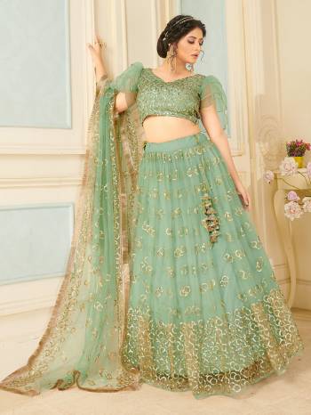 Heavy Designer Lehenga Choli And Dupatta In Light Color Fabricated On Soft Net Beautified With Heavy Attractive Sequance Thread Dori Embroidery. 