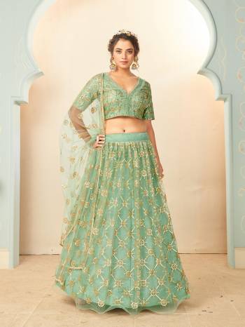 Heavy Designer Lehenga Choli And Dupatta In Light Color Fabricated On Soft Net Beautified With Heavy Attractive Sequance Thread Dori Embroidery. 