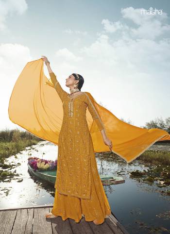 Attract All Wearing This Designer Suit In Yellow Ocher Color. Its Pretty Top Is Fabricated On Georgette Paired With Georgette Fabricated Bottom and Net Dupatta. This Suit's Top, Bottom And Dupatta Are Beautified With Detailed Heavy Embroidery. Buy This Pretty Piece Now.