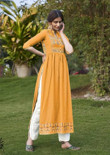 Grab This Readymade Long Kurti In Fawn Color Fabricated On Rayon Beautified With Foil Prints. It Is Light In Weight And Easy To Carry All Day Long. 