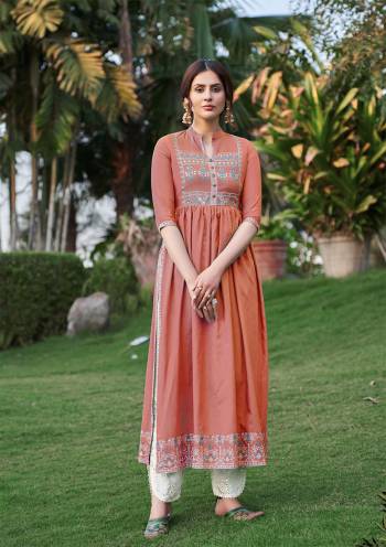 Grab This Readymade Long Kurti In Salmon Color Fabricated On Rayon Beautified With Foil Prints. It Is Light In Weight And Easy To Carry All Day Long. 