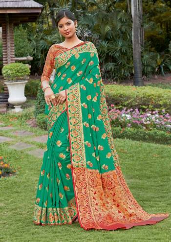 Look Attractive Wearing This Sea Green Colored Saree Paired With Maroon Colored Blouse.  This Heavy Designer Saree Is Banarasi Silk Based Which Gives A Rich Look To Your Personality. Buy This Pretty Saree Now.