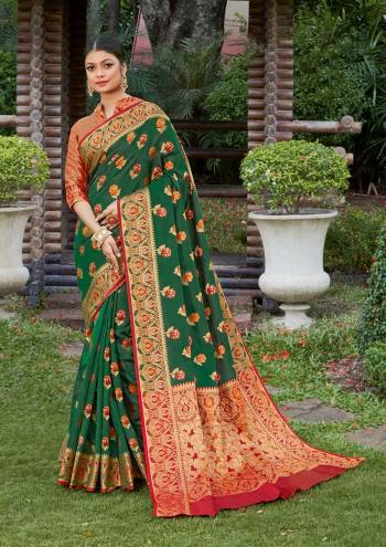 Look Attractive Wearing This Green Colored Saree Paired With Maroon Colored Blouse.  This Heavy Designer Saree Is Banarasi Silk Based Which Gives A Rich Look To Your Personality. Buy This Pretty Saree Now.