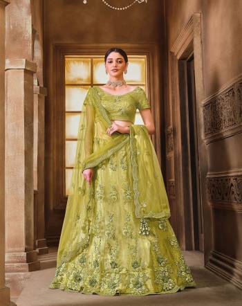 This Wedding Session Heavy Designer Lehenga Choli In Lime Green Color Fabricated On Net Beautified With Heavy Attractive Embroidery And Net Fabricated Dupatta. 