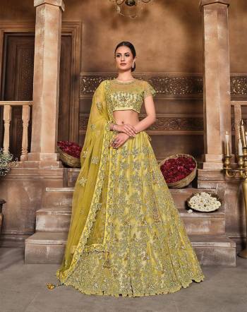 This Wedding Session Heavy Designer Lehenga Choli In Yellow Color Fabricated On Net Beautified With Heavy Attractive Embroidery And Net Fabricated Dupatta. 