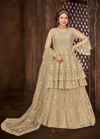 Look Pretty This Designer Floor Length Suit In Lovely Beige Color.?Its Pretty Embroidred And Stone Work Top And Bottom Is Net Based Paired With And Net Fabricated Embroidered With Stone Work Dupatta Which Gives An Attractive To The Suit.