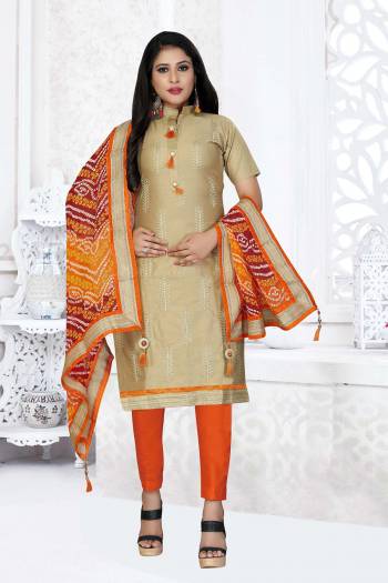 Grab This Very Beautiful And Elegant Looking Designer Straight Suit In Beige Color Paired With Orange Colored Bottom And Dupatta. Its Pretty Elegant Embroidered Top Is Fabricated On Glass Cotton Paired With Cotton Bottom and Georgette Fabricated Bandhani Printed Dupatta. 

