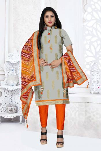 Grab This Very Beautiful And Elegant Looking Designer Straight Suit In Grey Color Paired With Orange Colored Bottom And Dupatta. Its Pretty Elegant Embroidered Top Is Fabricated On Glass Cotton Paired With Cotton Bottom and Georgette Fabricated Bandhani Printed Dupatta. 

