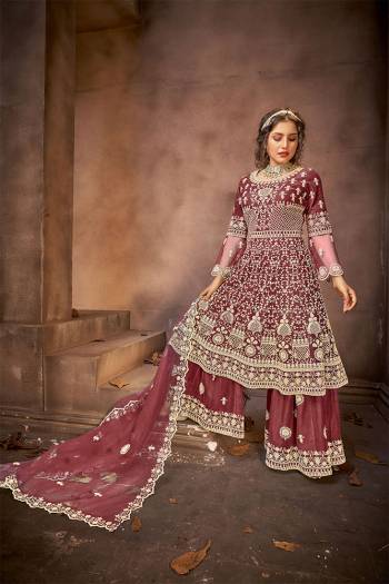 Go with The Lovely Shades Of Wine Wearing This Designer Straight Suit. Its Top Is Fabricated On Net Paired With Net Fabricated Bottom And Net Fabricated Dupatta with Heavy Embroidery Stone Work. 

