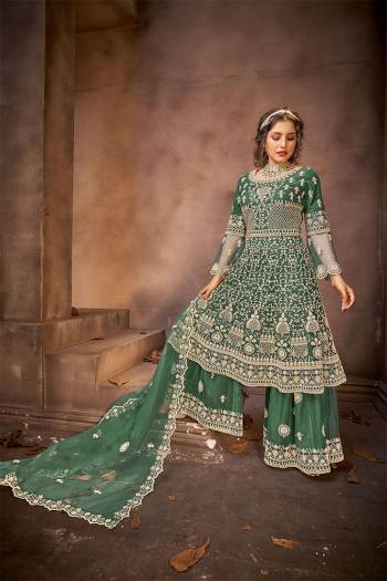 Go with The Lovely Shades Of Green Wearing This Designer Straight Suit. Its Top Is Fabricated On Net Paired With Net Fabricated Bottom And Net Fabricated Dupatta with Heavy Embroidery Stone Work. 

