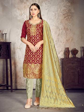 Here Is A Rich And Elegant Looking Silk Based Straight Suit In Dark Colored Top Paired With Matching Colored Bottom And Dupatta. Its Top And Dupatta Are Fabricated On Banarasi Silk Paired with Art Silk Bottom.

