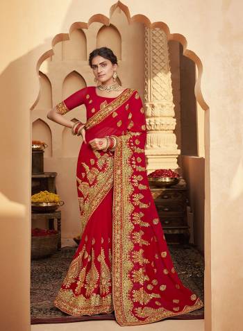 Celebrate This Wedding Festive Season In This Very Pretty Red Colored Designer Saree Paired With Matching Colored Blouse. This Saree and Blouse Are Heavy Blooming Georgette Based Beautified With Detailed Heavy Embroidery And Diamond Work. 