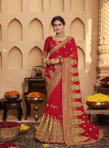 Celebrate This Wedding Festive Season In This Very Pretty Red Colored Designer Saree Paired With Matching Colored Blouse. This Saree and Blouse Are Heavy Blooming Georgette Based Beautified With Detailed Heavy Embroidery And Diamond Work. 