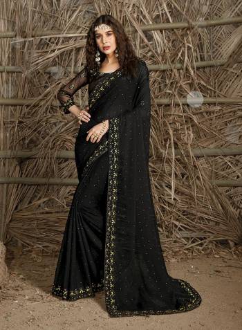 Celebrate This Festive Season In This Very Pretty Black Colored Designer Saree Paired With Blouse. This Saree and Blouse Are Chiffon Based Beautified With Detailed Cut Work Heavy Embroidery And Machine Diamond Work. 